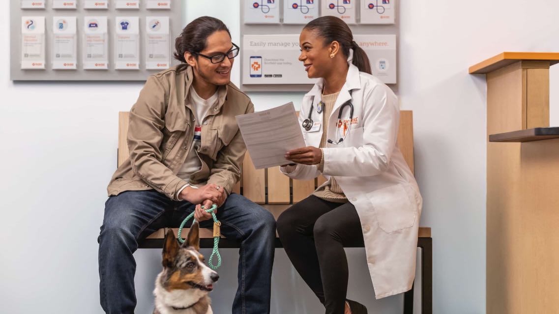 Doctor examining dog with her owner